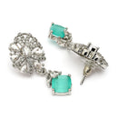 Rhodium Plated Silver Toned Leaf Shaped White And Sea Green American Diamond Studded Drop Earrings
