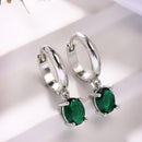 Rhodium Plated Silver Toned Oval Shaped Green American Diamond Studded Hoop Earrings