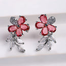 Rhodium Plated Silver Toned Floral Shaped Red & White American Diamond Studded Stud Earrings