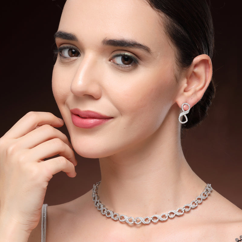Rhodium Plated Silver Toned Infinity Shaped White American Diamond Studded Necklace With Earrings Jewellery