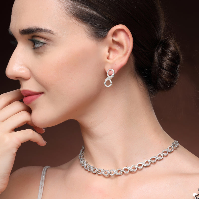 Rhodium Plated Silver Toned Infinity Shaped White American Diamond Studded Necklace With Earrings Jewellery