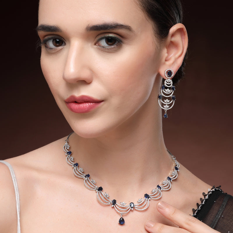 Rhodium Plated Silver Toned Crescent Shaped Blue & White American Diamond Studded Necklace With Earrings Jewellery Set
