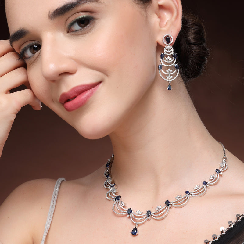 Rhodium Plated Silver Toned Crescent Shaped Blue & White American Diamond Studded Necklace With Earrings Jewellery Set