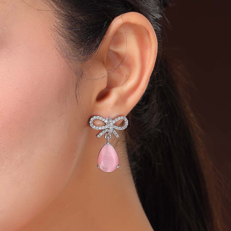 Rhodium Plated Silver Toned Bow Shaped Pink & White American Diamond Studded Drop Earrings