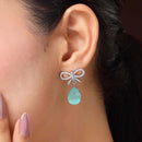 Rhodium Plated Silver Toned Bow Shaped Sea Green & White American Diamond Studded Drop Earrings