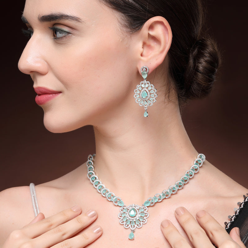 Rhodium Plated Silver Toned Ornate Shaped Sea Green & White American Diamond Studded Jewellery Set