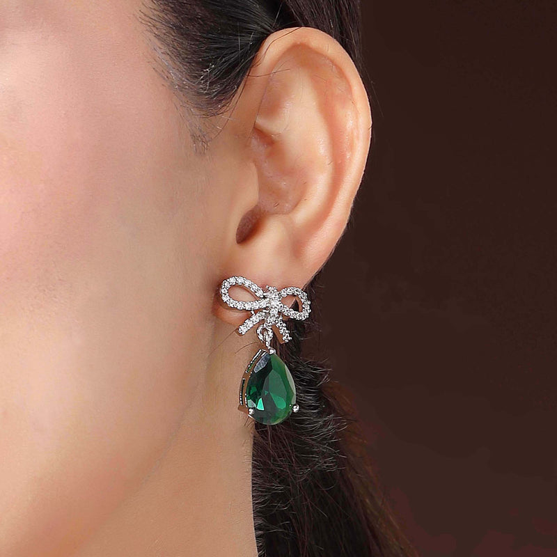 Rhodium Plated Silver Toned Bow Shaped Green & White American Diamond Studded Drop Earrings