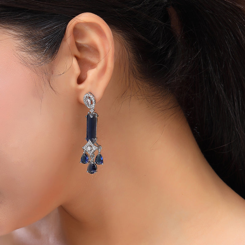 Rhodium Plated Silver Toned Bar Shaped Blue & White American Diamond Studded Earrings