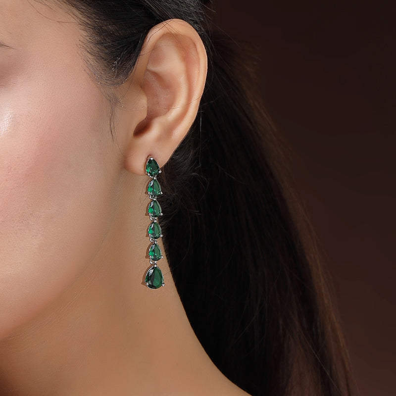 Rhodium Plated Silver Toned Teardrop Shaped Green American Diamond Studded Linear Dangler Earrings