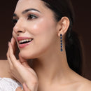 Rhodium Plated Silver Toned Teardrop Shaped Navy Blue American Diamond Studded Linear Dangler Earrings