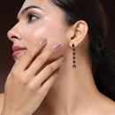 Rhodium Plated Silver Toned Teardrop Shaped Purple American Diamond Studded Linear Dangler Earrings