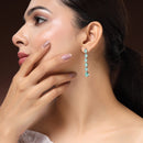 Rhodium Plated Silver Toned Teardrop Shaped Sea Green American Diamond Studded Linear Dangler Earrings