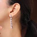 Rhodium Plated Silver Toned Teardrop Shaped Pink American Diamond Studded Linear Dangler Earrings