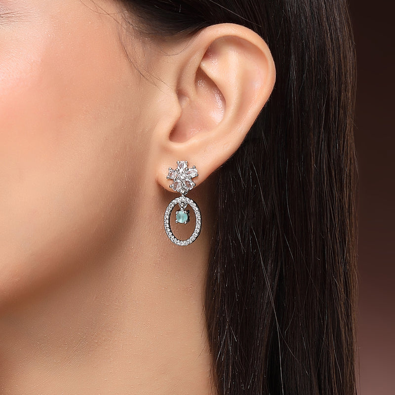 Rhodium Plated Silver Toned Floral Oval Shaped Sea Green &White American Diamond Studded Drop Earrings