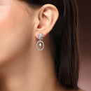 Rhodium Plated Silver Toned Floral Oval Shaped White American Diamond Studded Drop Earrings