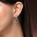 Rhodium Plated Silver Toned Floral Oval Shaped Green & White American Diamond Studded Drop Earrings