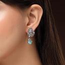 Rhodium Plated Silver Toned Leaf Shaped White And Sea Green American Diamond Studded Drop Earrings