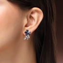 Rhodium Plated Silver Toned Floral Shaped Navy Blue & White American Diamond Studded Stud Earrings