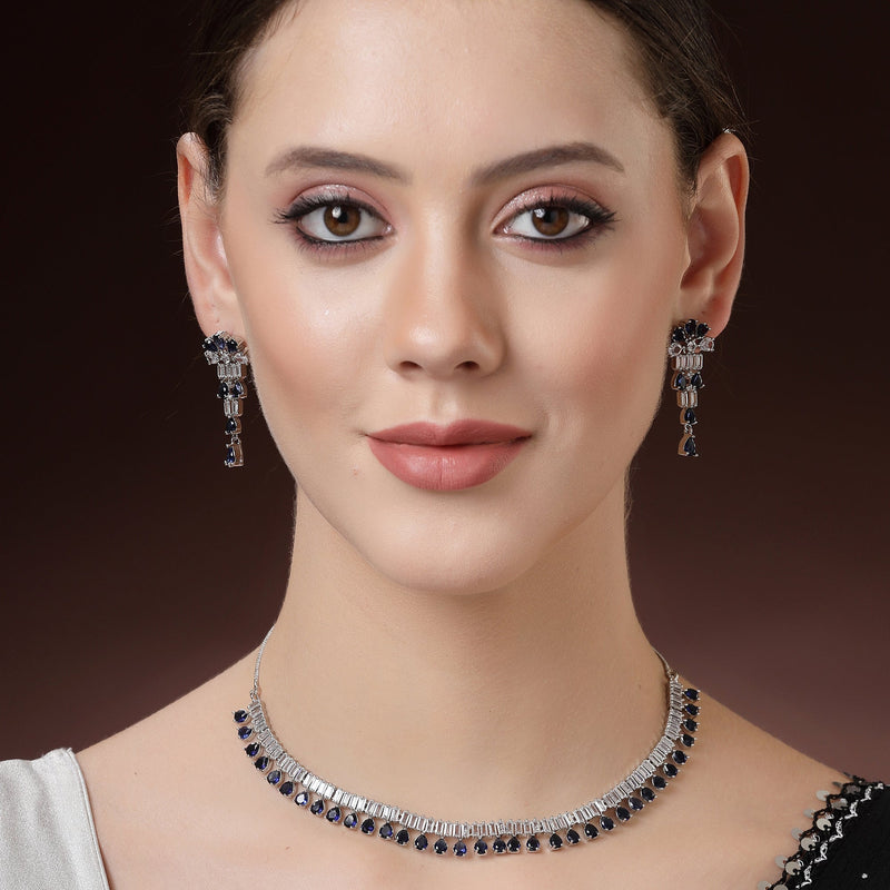 Rhodium Plated Silver Toned Blue American Diamond  Studded Classic Necklace With Floral Drop Earrings