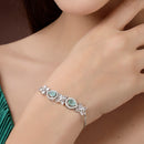 Rhodium Plated Silver Toned White Flower & Mint Green Teardrop American Diamond Studded Wraparound Adjustable Bracelet