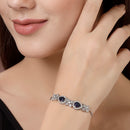Rhodium Plated Silver Toned White Flower & Blue Teardrop American Diamond Studded Wraparound Adjustable Bracelet