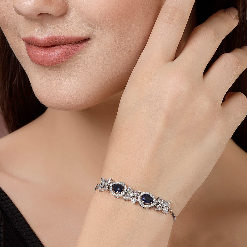 Rhodium Plated Silver Toned White Flower & Blue Teardrop American Diamond Studded Wraparound Adjustable Bracelet