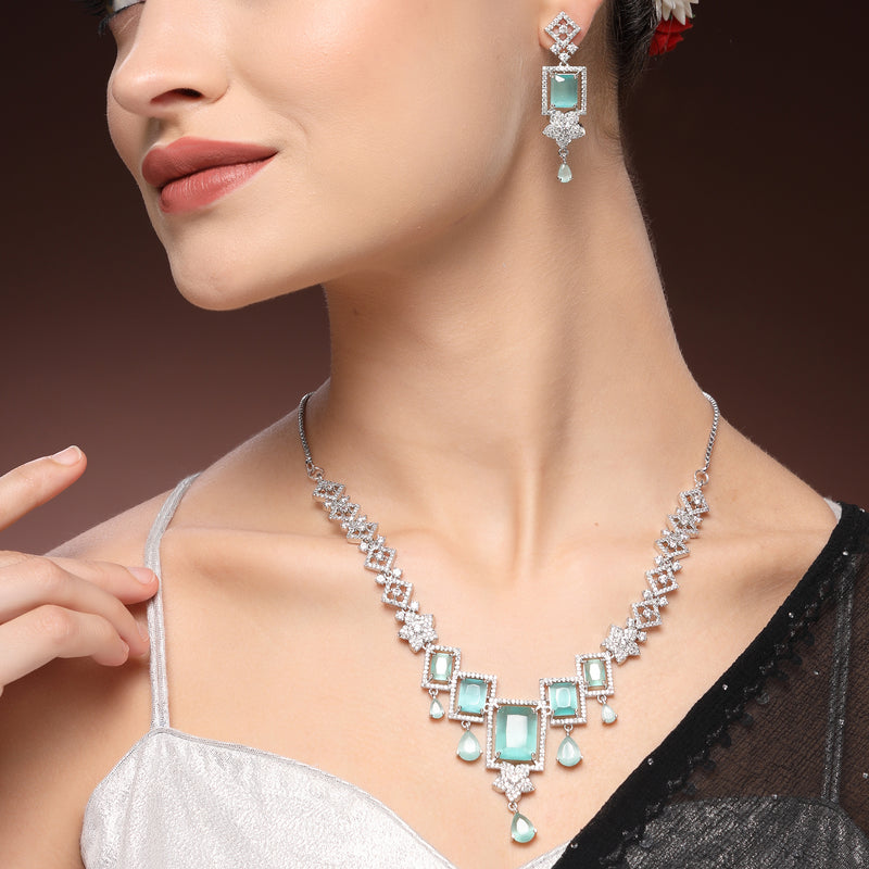Rhodium Plated Silver Toned Rectangular Shaped Sea Green & White American Diamond Studded Jewellery Set