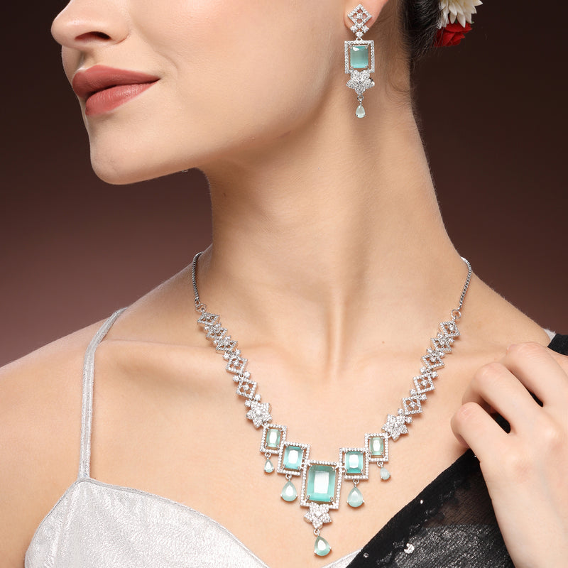 Rhodium Plated Silver Toned Rectangular Shaped Sea Green & White American Diamond Studded Jewellery Set