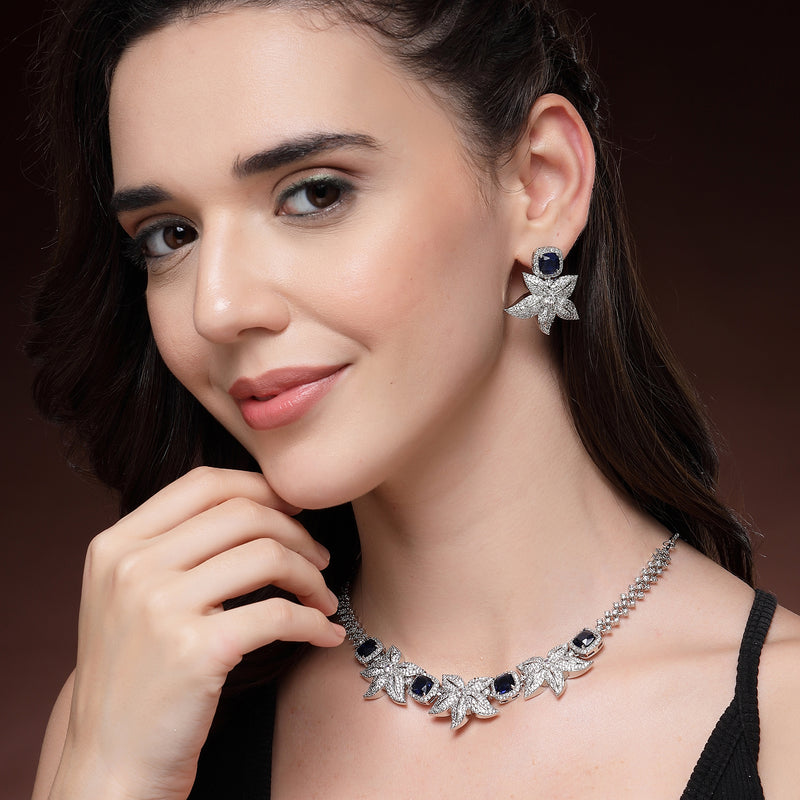 Rhodium Plated Silver Toned Floral Shaped Blue & White American Diamond Studded Jewellery Set