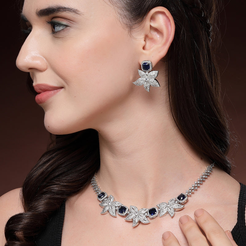 Rhodium Plated Silver Toned Floral Shaped Blue & White American Diamond Studded Jewellery Set