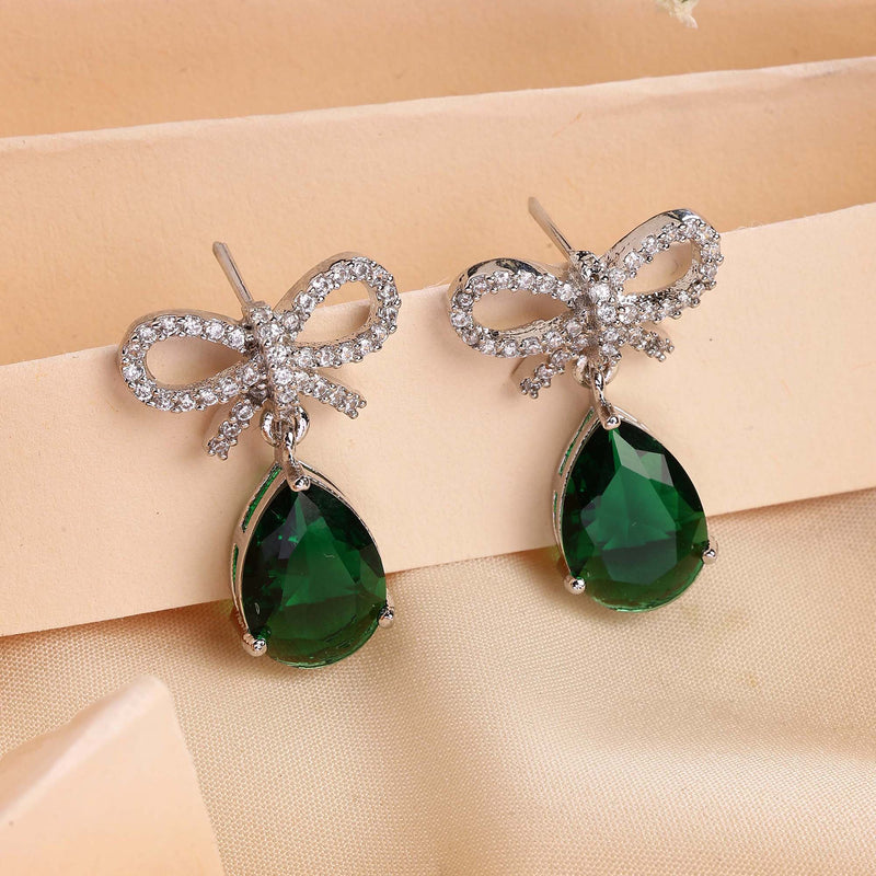 Rhodium Plated Silver Toned Bow Shaped Green & White American Diamond Studded Drop Earrings