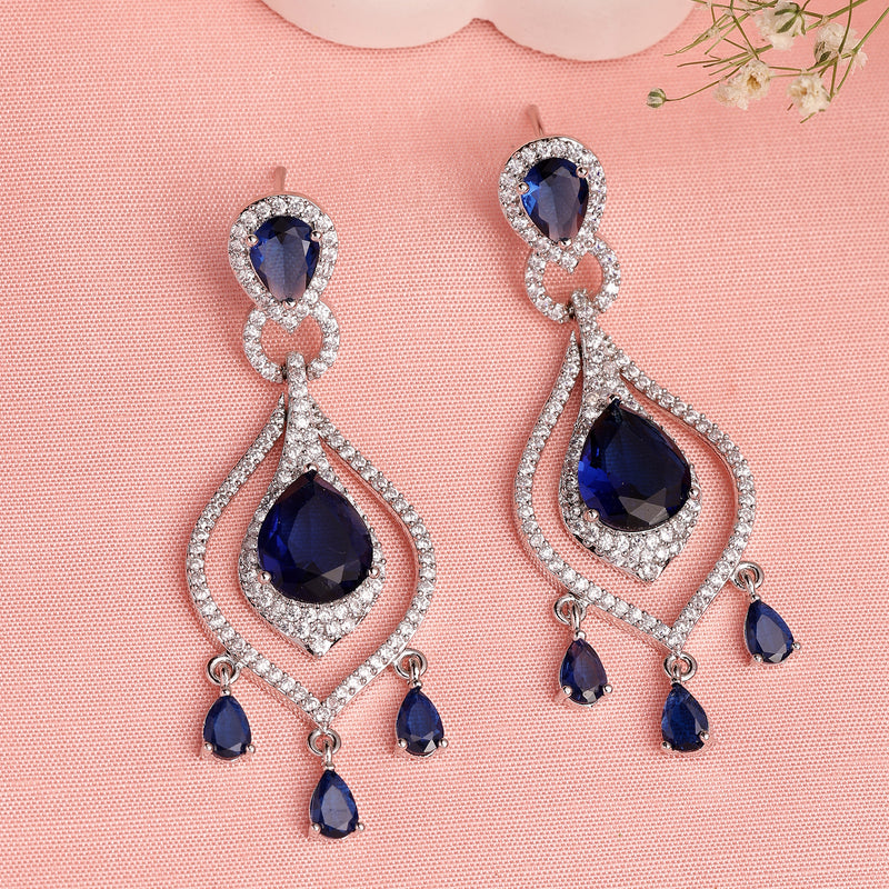 Rhodium Plated Silver Toned Teardrop Shaped Blue & White American Diamond Studded Earrings