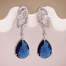 Rhodium Plated Silver Toned Teardrop Shaped Navy Blue & White American Diamond Studded Drop Earrings