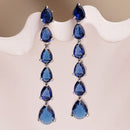 Rhodium Plated Silver Toned Teardrop Shaped Navy Blue American Diamond Studded Linear Dangler Earrings