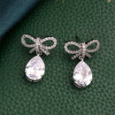 Rhodium Plated Silver Toned Bow Shaped White American Diamond Studded Drop Earrings
