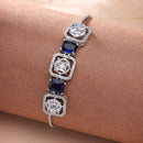Rhodium Plated Silver Toned White Round & Blue Rectangle American Diamond Wraparound Adjustable Bracelet