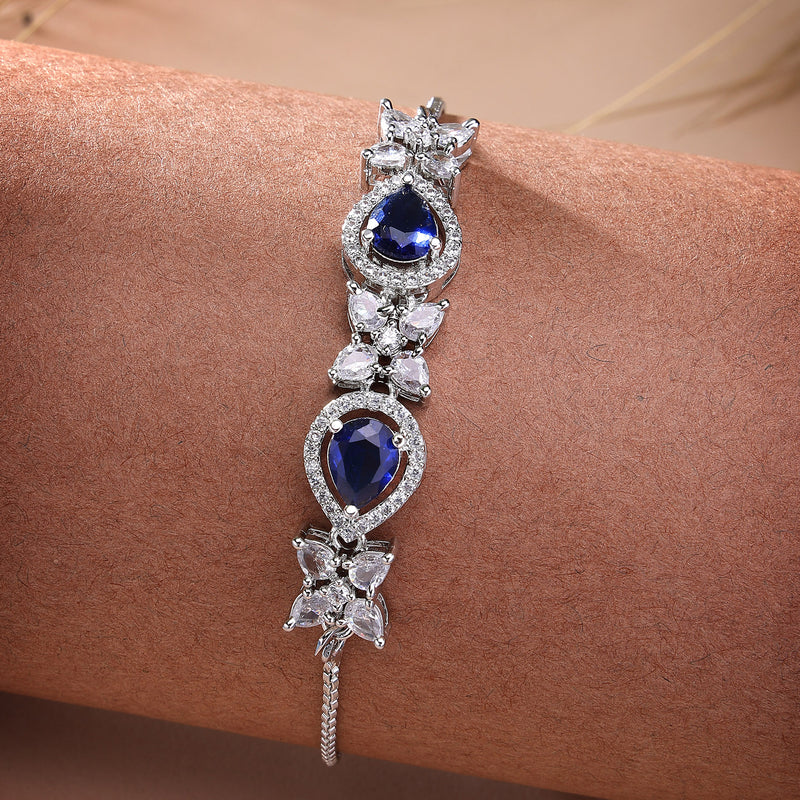 Rhodium Plated Silver Toned White Flower & Blue Teardrop American Diamond Studded Wraparound Adjustable Bracelet