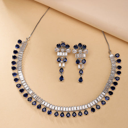 Rhodium Plated Silver Toned Blue American Diamond  Studded Classic Necklace With Floral Drop Earrings