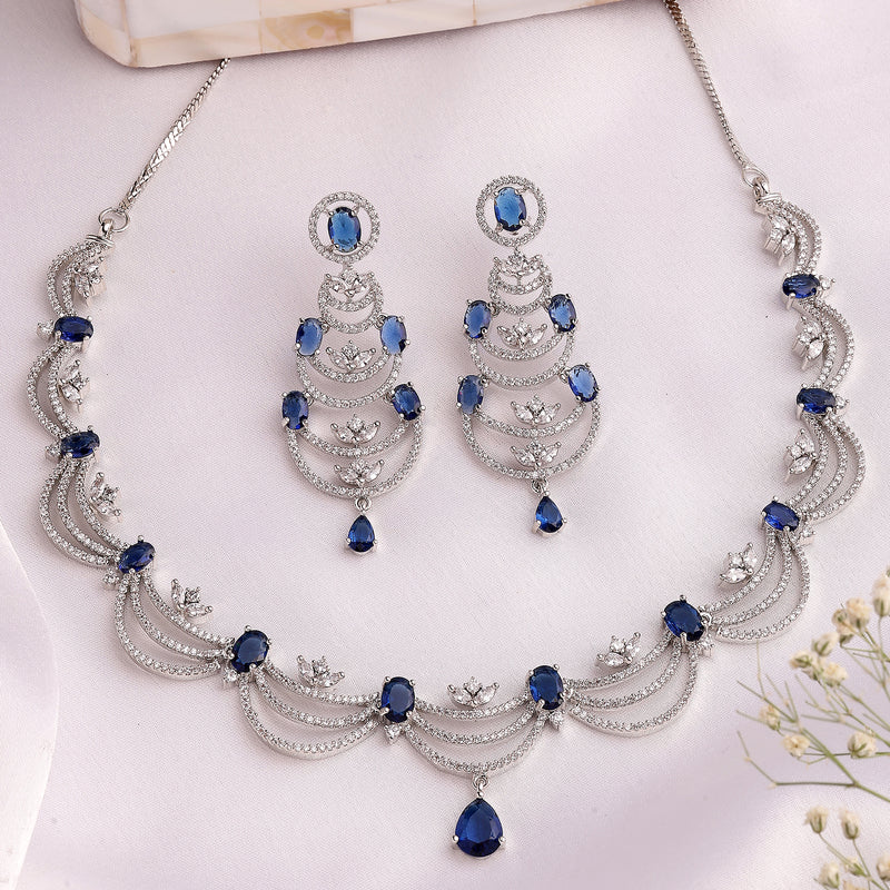 Rhodium Plated Silver Toned Crescent Shaped Blue & White American Diamond Studded Necklace With Earrings Jewellery Set