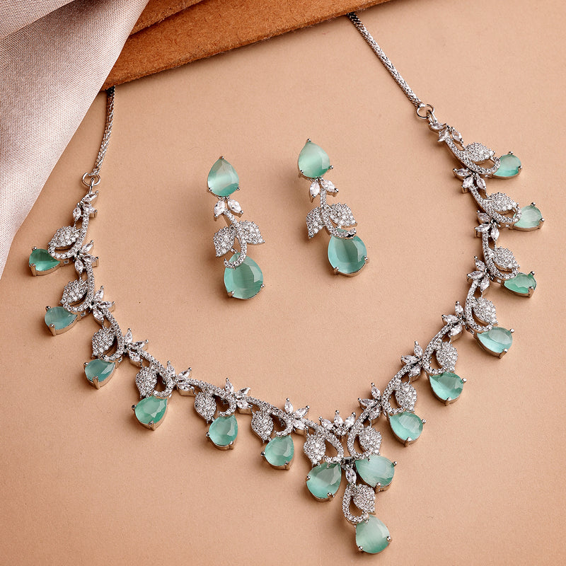 Rhodium Plated Silver Toned Leaf Teardrop Shaped Sea Green & White American Diamond Studded Jewellery Set