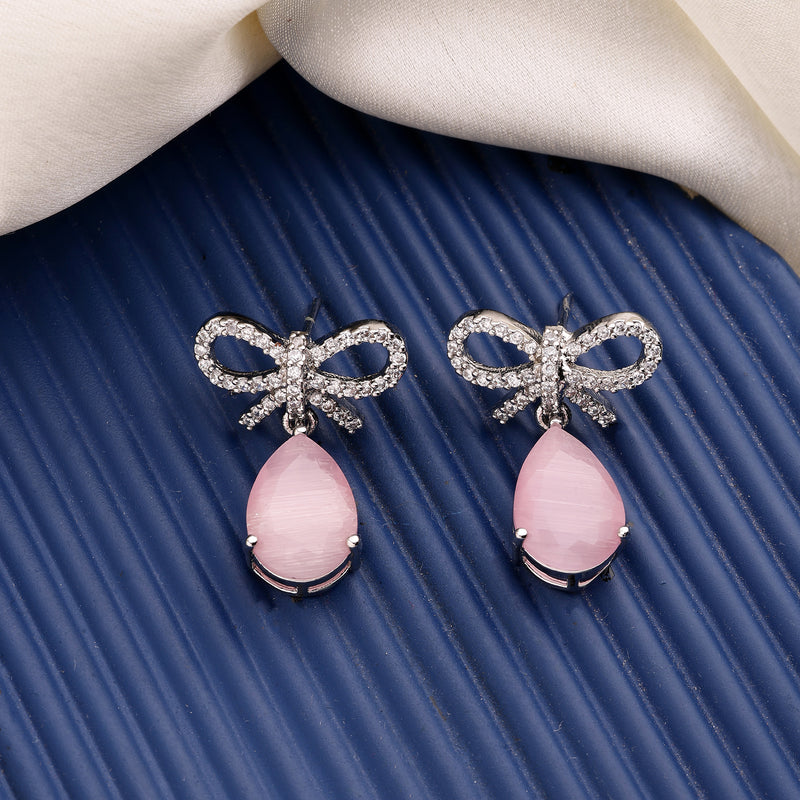 Rhodium Plated Silver Toned Bow Shaped Pink & White American Diamond Studded Drop Earrings