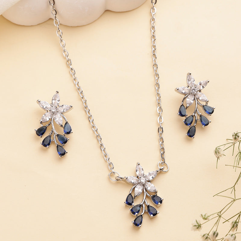 Rhodium Plated Silver Toned Blue And White American Diamond Studded Floral Teardrop Shaped Pendant Set
