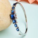 Rhodium Plated Silver Toned Square Shaped Blue American Diamond Studded Bracelet