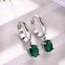 Rhodium Plated Silver Toned Oval Shaped Green American Diamond Studded Hoop Earrings