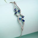 Rhodium Plated Silver Toned Floral Royal Blue American Diamond Studded Bracelet