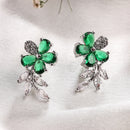 Rhodium Plated Silver Toned Floral Shaped Green & White American Diamond Studded Stud Earrings