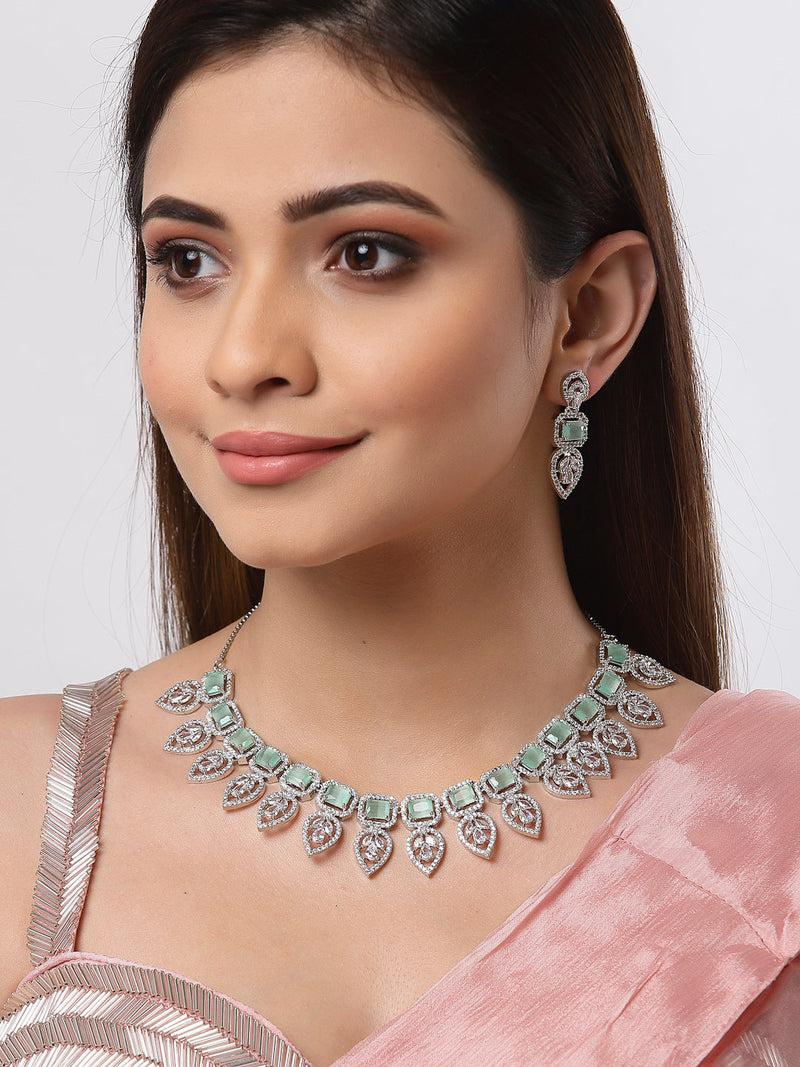 Rhodium Plated Silver Toned Teardrop Floral Design White  & Sea Green Square AD Studded Necklace Set & Matching Earrings