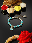 Gold Plated Gold Toned Sky Blue & White Shell Charm Studded Rakhi Bracelet