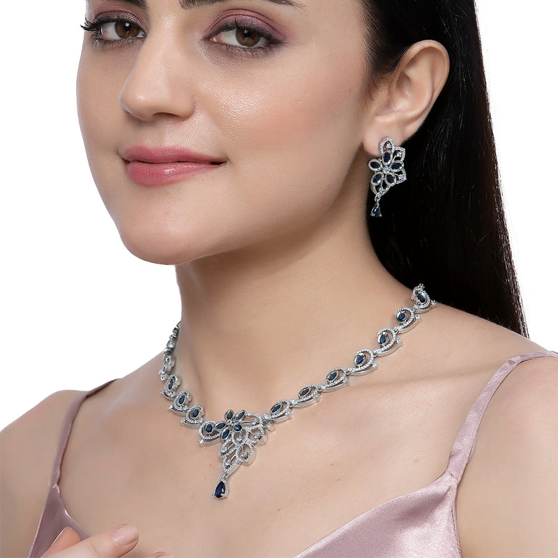 Rhodium-Plated Navy Blue American Diamond Studded Floral & Paisley Shaped Necklace with Earrings Jewellery Set