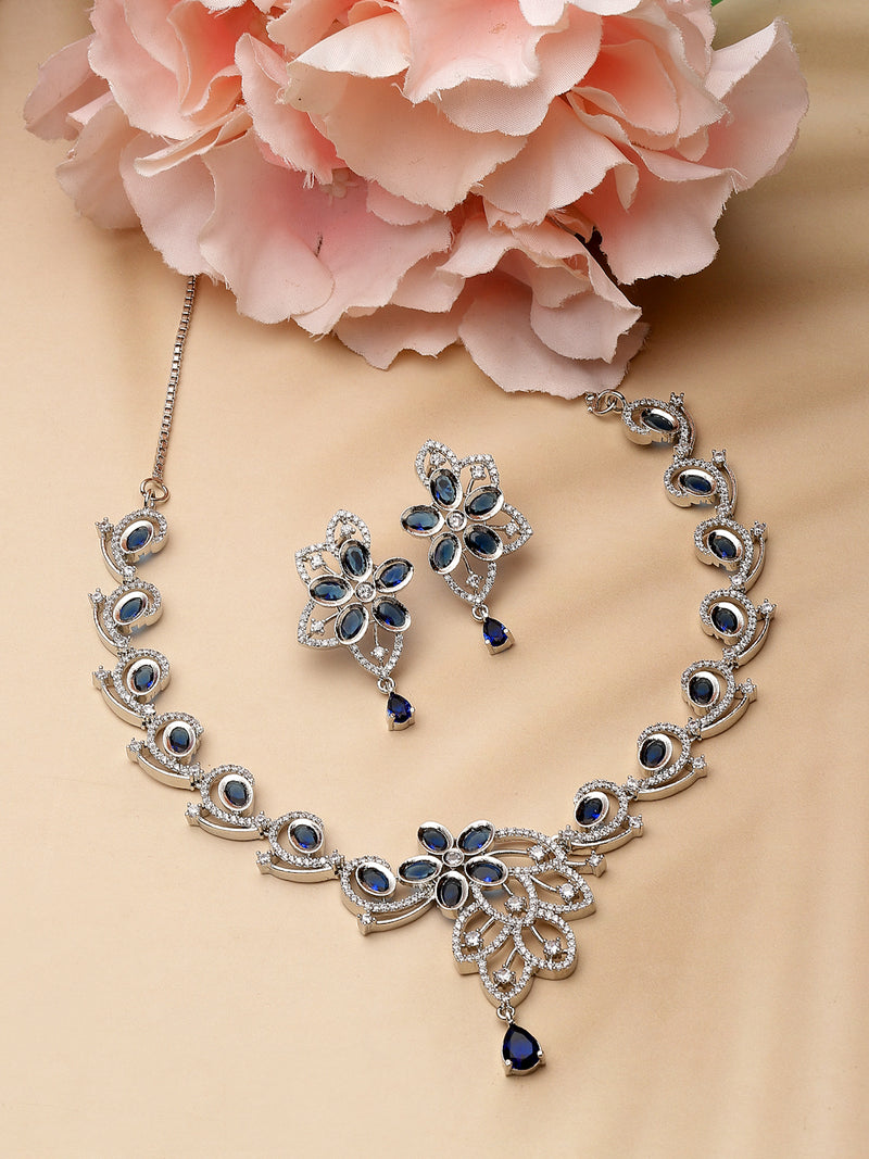 Rhodium-Plated Navy Blue American Diamond Studded Floral & Paisley Shaped Necklace with Earrings Jewellery Set